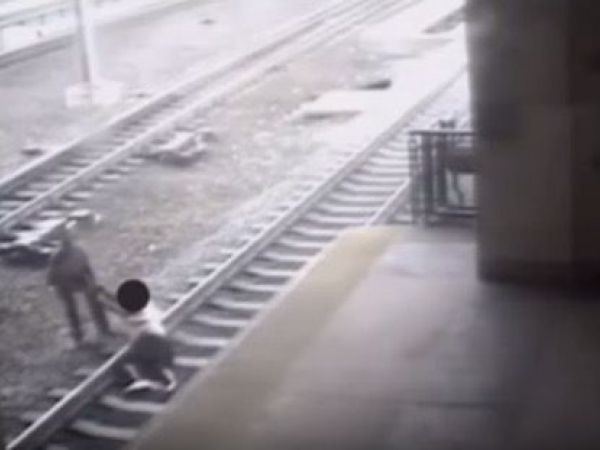Transit cop saves man lying on train tracks as train approaches